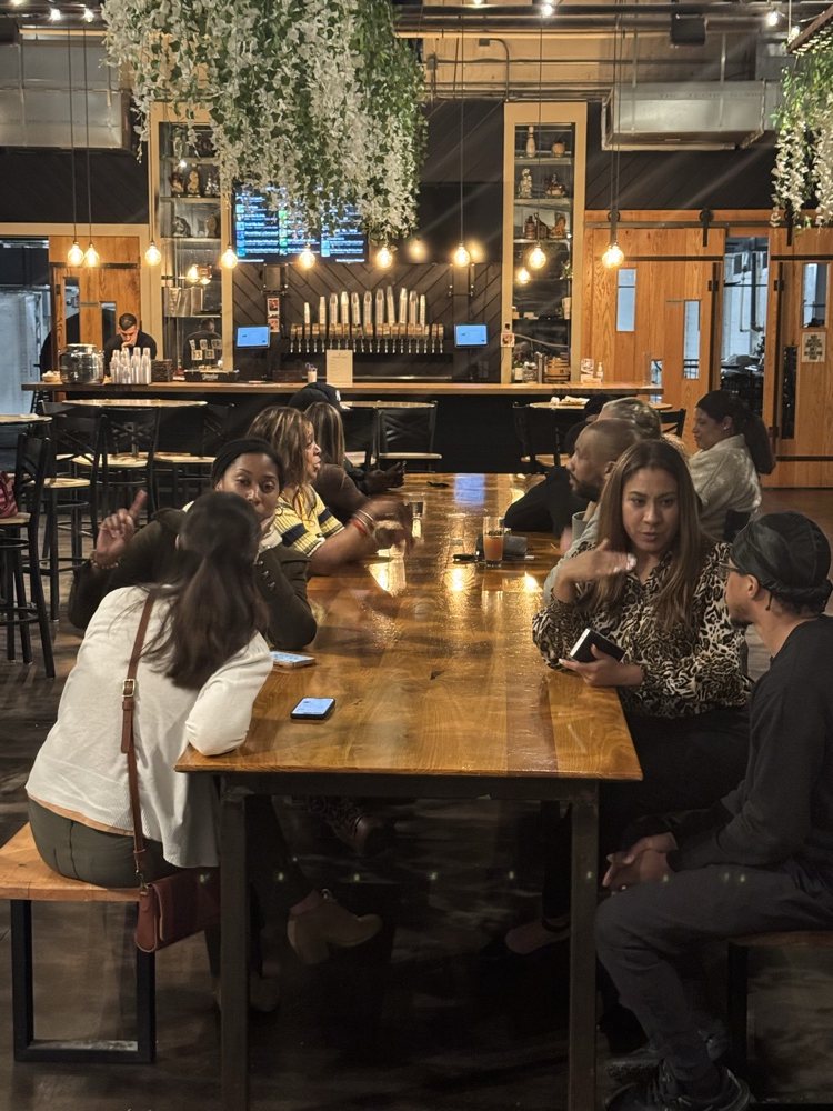 Members talking around a table at a meetup